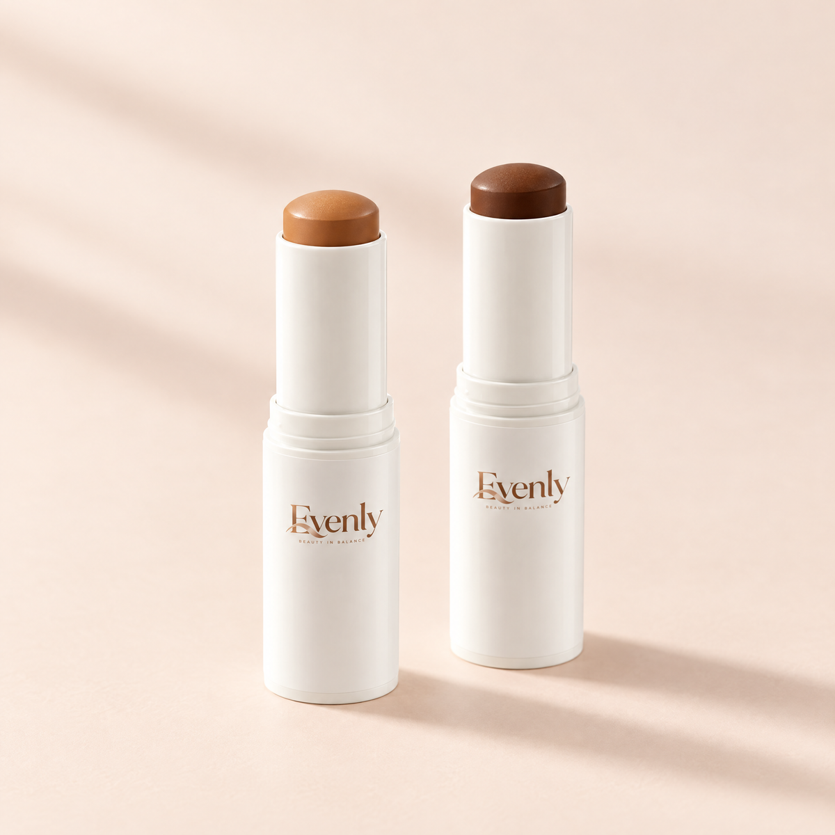 The Evenly Day Stick in Tan and Deep side by side, bullets twisted up to show both shades
