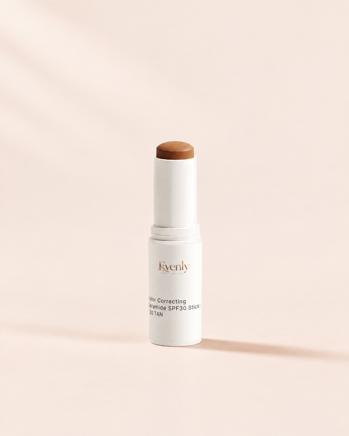 Evenly Day Stick in Tan, twisted up, on a warm cream background